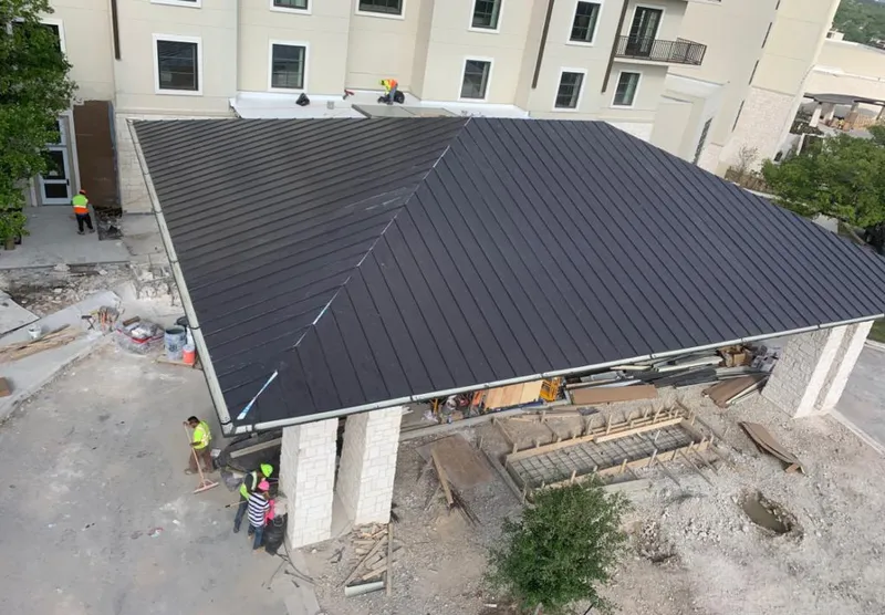 Metal roofing installation team working on a commercial building in Portage