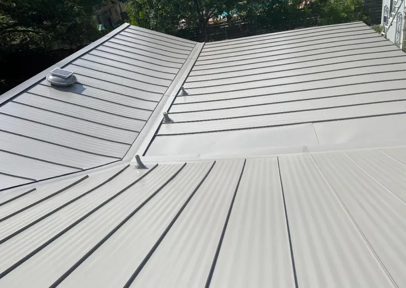 Solar attic fan installed on a metal roof for Roof Ventilation in Portage